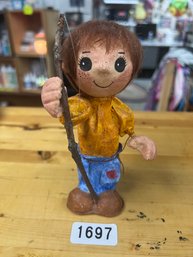 Statue Of Kid With Stick In Hand