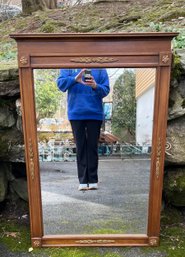 A Large Wooden Mirror With Neoclassical-style Gilded Ornamentation