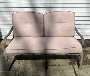 Outdoor Metal-framed Loveseat With Upholstered Cushions.