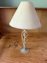 Decorative Table Lamp With A Twisted Metal Stem And Fabric Shade.