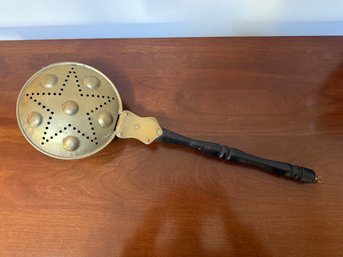Antique Brass Bed Warmer With A Punched Star Pattern And Wooden Handle.