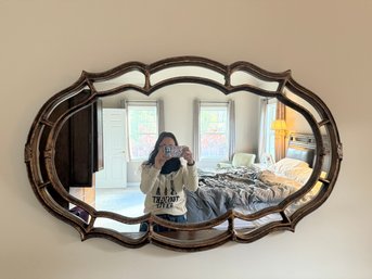 Ornate Oval Mirror With A Decorative, Antiqued Gilded Frame.