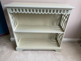 Light-colored, Two-shelf Decorative Bookcase With Cutouts.
