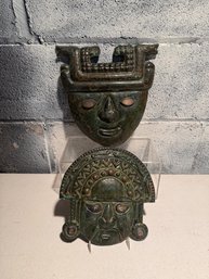 Two Decorative Bronze Or Copper Masks Inspired By Ancient Andean And Mesoamerican Art