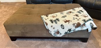 A Modern Tufted Ottoman Upholstered In Suede-like Fabric And Baby Rich By Wool Rich Throw