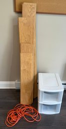 Wood Planks, Plastic Drawers, And Orange Extension Cord