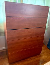 A Modern Five-drawer Wooden Dresser With Integrated Drawer Pulls