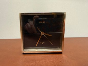 This Is A Vintage Seiko Quartz Desk Clock With A Black Face And Gold Frame