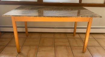 Dining Table With A Granite Top And Wooden Legs.