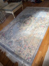 Blue Decorative Area Rug With A Traditional Floral And Scrolling Leaf Design.