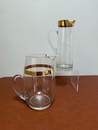 Set Of Two Vintage Glass Pitchers With Gold Decorative Accents.