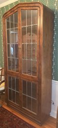 Wooden Display Cabinet With Mullioned Glass Doors And Decorative Hardware