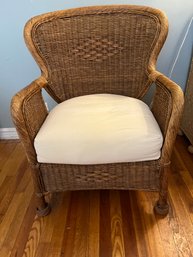 Vintage Rattan Wicker Lounge Armchair With A Cream Cushion.