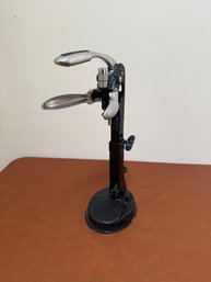 Light Weight A Modern Tabletop Wine Opener With Silver Levers And A Black Base.