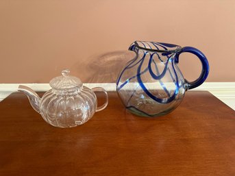 Hand-blown Glass Pitcher With Blue Swirls And A Clear Glass Teapot.