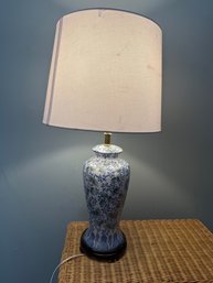 A Blue And White Floral Ceramic Table Lamp With A Linen Shade Missing Finial