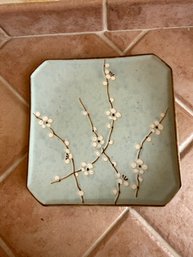 A Modern Japanese Ceramic Plate With A Matte Glaze And Cherry Blossom Design