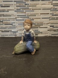 Royal Copenhagen Figurine Of A Boy On A Gourd.