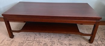 Dark Wood Coffee Table With A Lower Shelf And Simple Legs