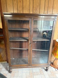 Vintage Dark Wood Display Cabinet With Glass Doors And Turned Feet