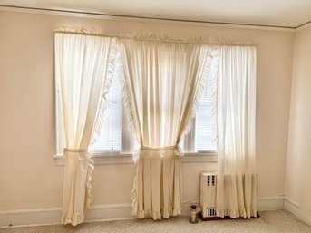Cream-colored Ruffled Tier Curtains With Gathered Tops And Tie-backs.