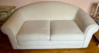 A Postmodern Upholstered Sofa With A Curved Back And Armrests