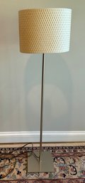 Modern Floor Lamp With A Woven Shade.
