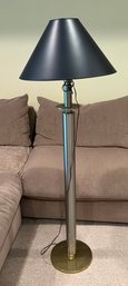 Mid-Century Modern Brushed Metal Floor Lamp With A Circular Base And Shade.