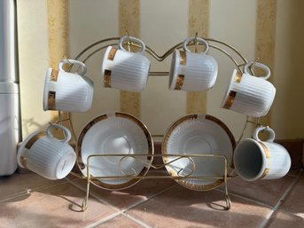 White Ribbed Teacups With Gold Rim Saucers, Arranged On A Heart-shaped Wire Display Rack