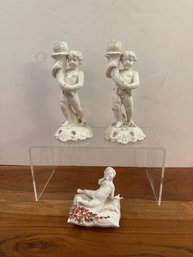 Pair Of White Porcelain Cherub Candle Holders With Ornate Bases & Porcelain Figurine Of A Reclining Cherub