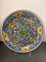 Hand-painted Mexican Ceramic Plate With Floral And Swirling Motifs.