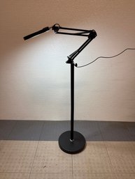 Black LED Magnifying Lamp With A Floor Stand And An Adjustable Swing Arm