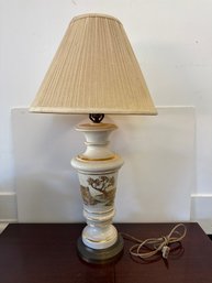 Decorative Porcelain Table Lamp With A Painted Scene And Gold Trim.