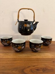 Vintage Japanese Black Porcelain Tea Set With Floral Motifs And Wicker Handle