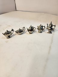 # 109 Teapot Shaped Metal Napkin Rings