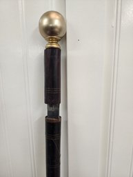 #275 WALKING STICK/CANE WITH A SWORD STUCK IN IT