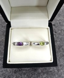2 Ladies Silver Rings With What Appers To Be Peridot And Amethyst Center Stones