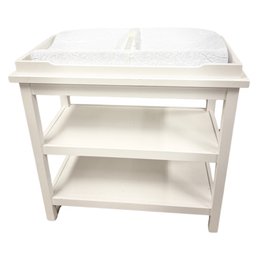 White Wooden Changing Table With Two Shelves And Contoured Changing Pad