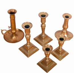 A Grouping Of Antique Brass Candlesticks