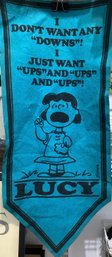 Blue Felt Banner Featuring The Character Lucy From The 'Peanuts' Comic Strip