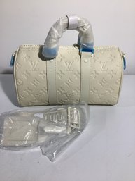 Light-colored, Embossed Monogram Hand Bag