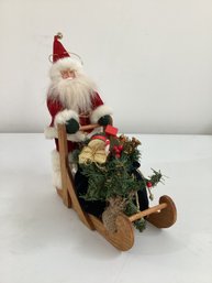 Santa Pushing A Rustic Wooden Sleigh