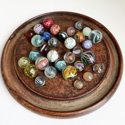 Marble Collection Displayed On Wooden Solitaire Board.