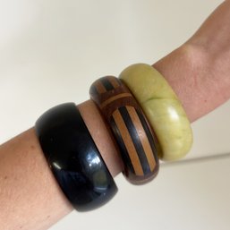 Three Costume Jewelry Bangle Bracelets: Two Hard Plastic/lucite And One Dark Wood Inlay Stripes