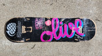 Olive Skateboard Co Pink And Blue Script Logo Black 7-Ply Maple Skateboard Deck With Thunder Trucks Sticker
