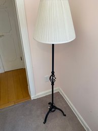 Black Wrought Iron Floor Lamp With A Twisted Detailing Stem And A White Pleated Shade