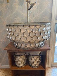 Transitional Tiered Chandelier & Sconces And A Burnished Silver Steel Drum Frame And Clear Crystals