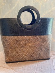 TLC Straw And Leather Bucket Tote Bag Featuring Round Handles And A Woven Body