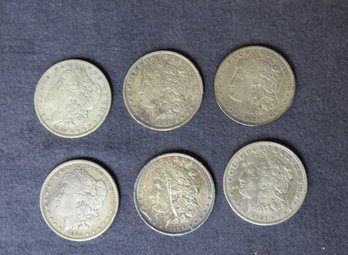 Six Morgan Silver Dollars, 1889-O, 1882-O, 1921-D, 1884, 1889, 1921