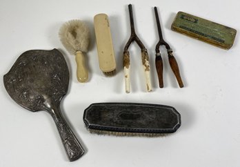 Antique Or Vintage Vanity Or Dresser Items Including Brushes, Curling Irons, & A Razor Sharpening Stone